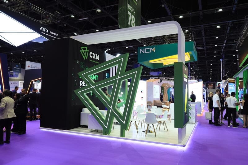 CXM stand with visitors at a trading expo